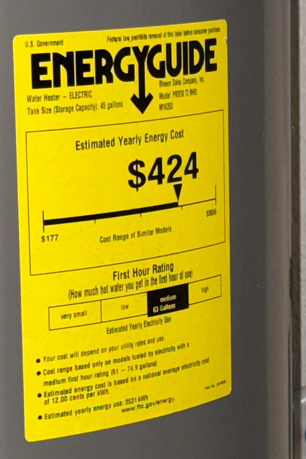 Photo of a yellow EnergyGuide label on an electric tank water heater showing a $424 estimated yearly energy cost
