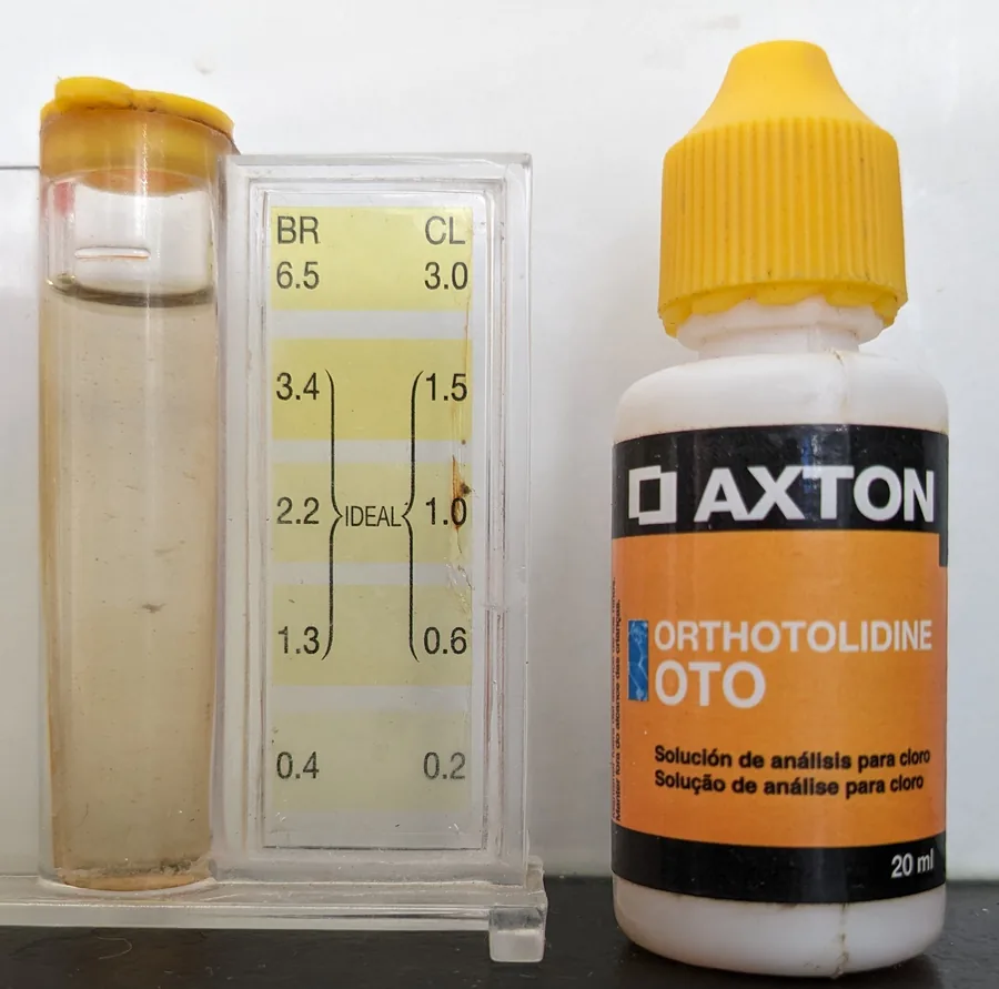 Photo of an orthotolidine pool chlorine drop test kit with a yellow color scale marked ideal