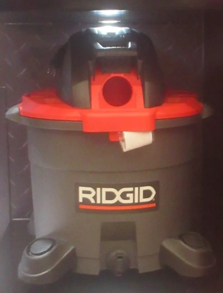 Photo of a red and gray wet/dry shop vacuum, the kind hot tub manuals use to clear jets and lines